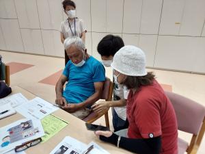 学生が個別指導でスマホを教えている様子です