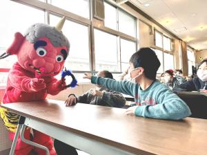 ツノを小学生に渡す酒店童子くん