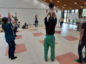 リトミックで子どもを親が高い高いをしている様子です