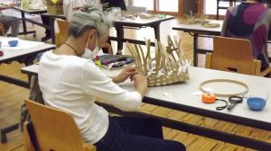 かごの角をきれいに折りながら編んでいる様子です