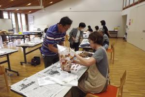 講師が和紙の貼り方を説明している様子です